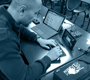 A man taking an iClass assessment at a desk