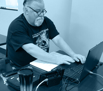 A man typing on a laptop